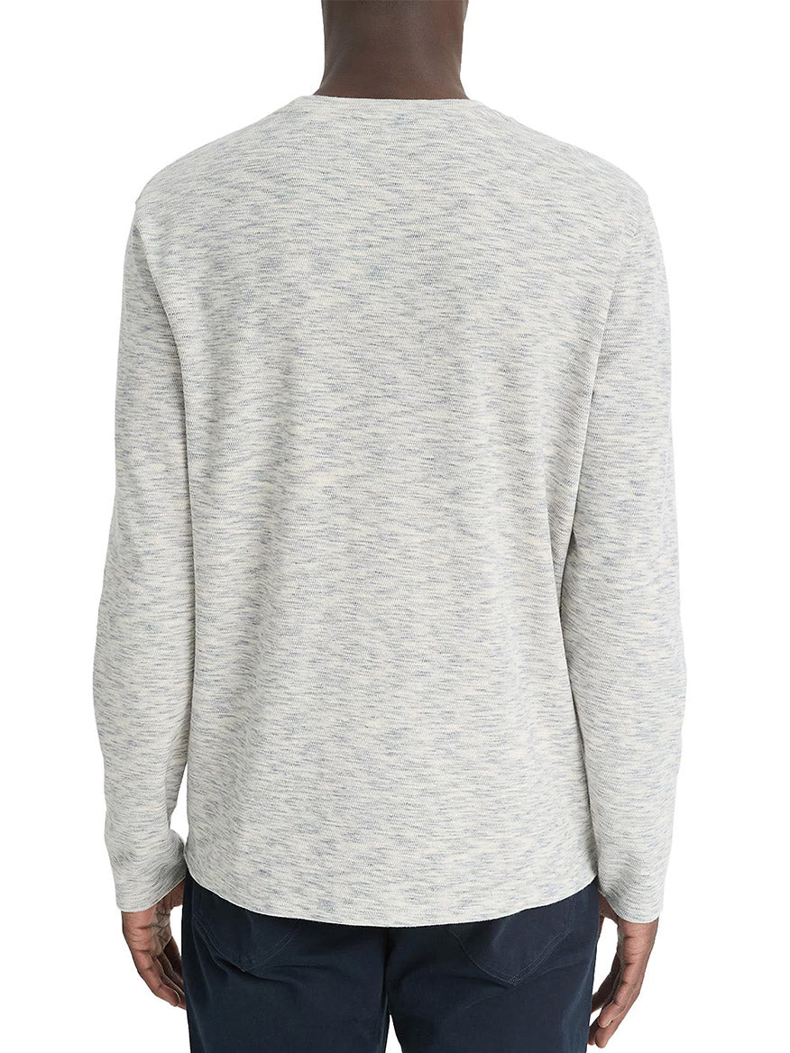 Person wearing the Vince Space-Dye Cotton-Blend Long-Sleeve T-Shirt in Blue Cloud/Off-White and dark pants, showcasing a speckled effect, facing away.