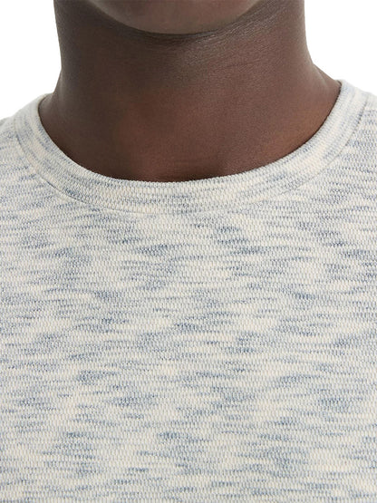 Close-up of a person wearing the Vince Space-Dye Cotton-Blend Long-Sleeve T-Shirt in Blue Cloud/Off-White, highlighting the neck and shoulder area.