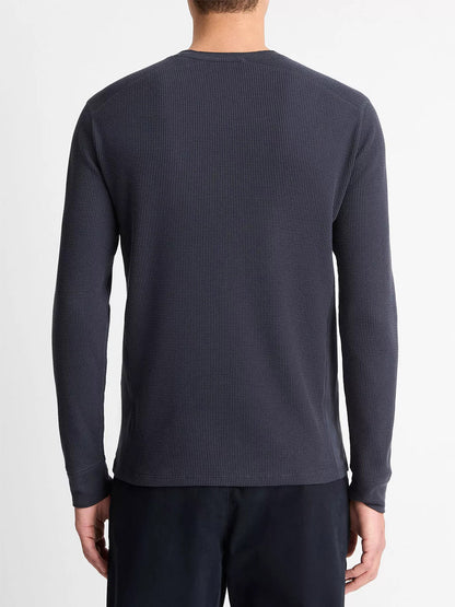A person is seen from behind wearing a Vince Thermal Long Sleeve Crew Neck Pullover in Coastal Blue and dark pants, standing against a plain white background.