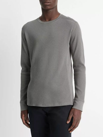 A person wearing the Vince Thermal Pima Cotton-Blend Long-Sleeve T-Shirt in Iron and black pants stands against a plain background.