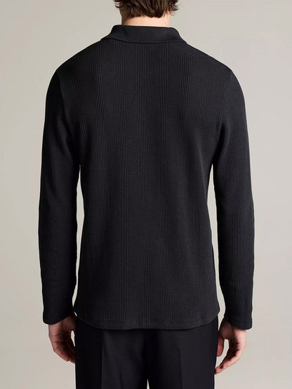 A person is shown from the back wearing the Vince Variegated Cotton Polo Shirt in Coastal Blue and black pants against a plain background.