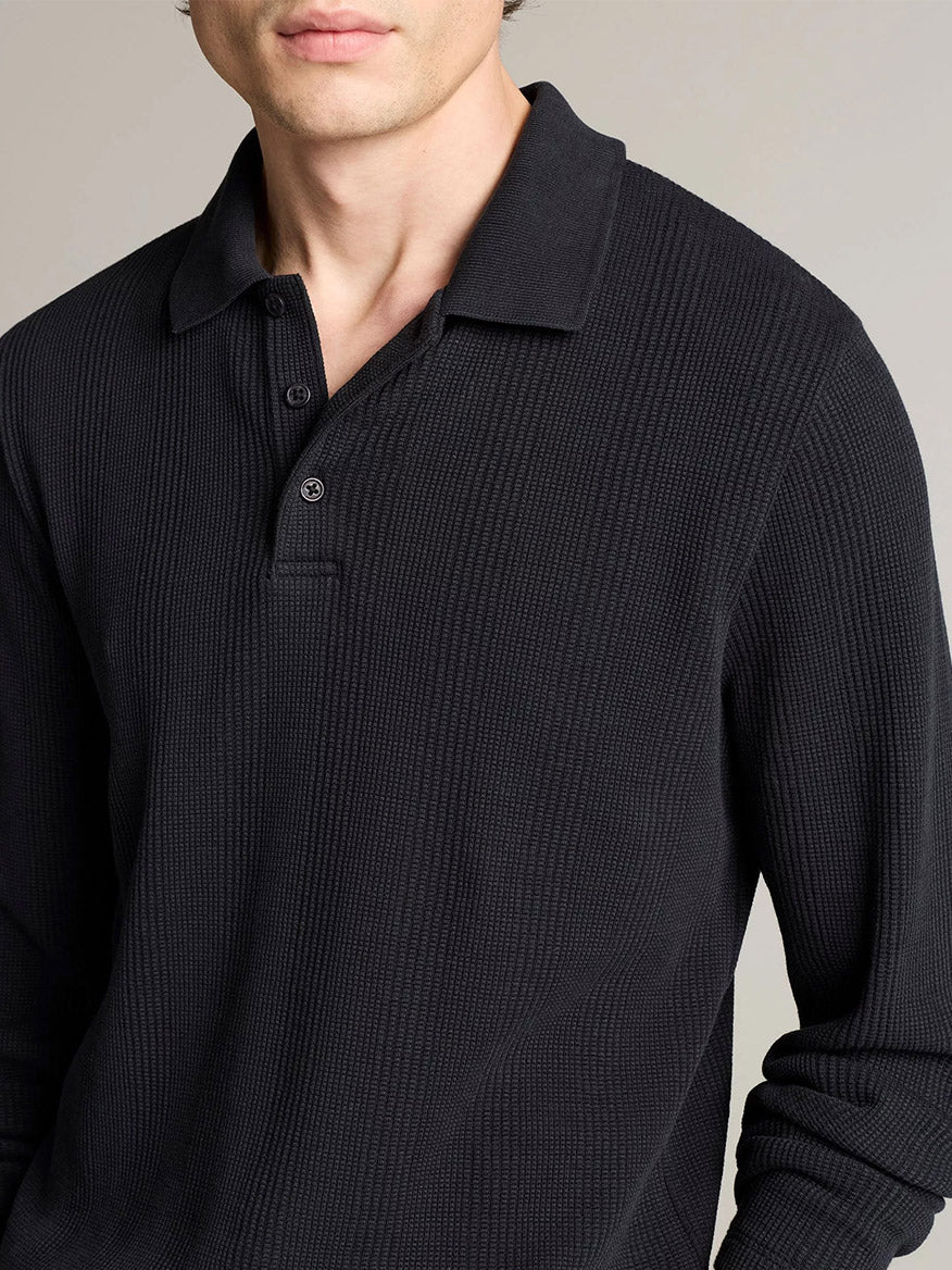 A person wearing a Vince Variegated Cotton Polo Shirt in Coastal Blue, shown from mid-chest up against a plain background.