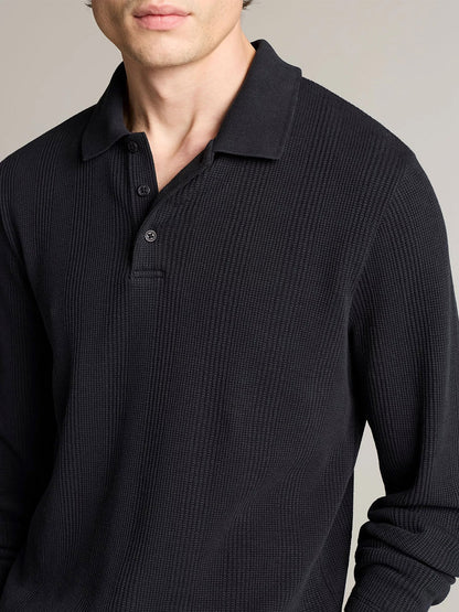 A person wearing a Vince Variegated Cotton Polo Shirt in Coastal Blue, shown from mid-chest up against a plain background.