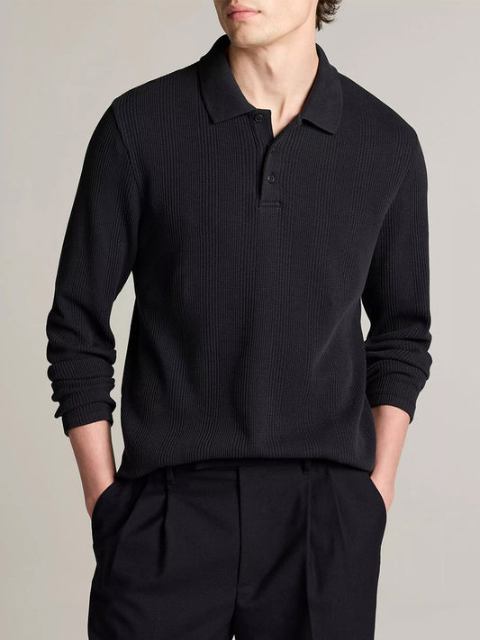 A person wears the Vince Variegated Cotton Polo Shirt in Coastal Blue with black pants, standing hands-in-pockets against a neutral background.