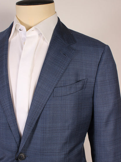 A mannequin wears the Zegna High Performance Bright Blue Suit jacket, featuring a blue plaid pattern, over a white dress shirt with the top button undone.