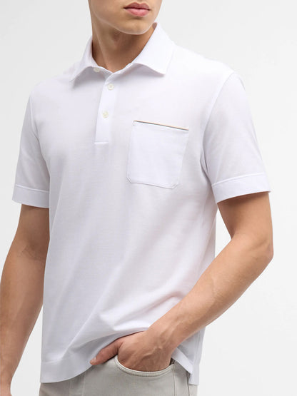 A person wearing a Zegna Polo Pure Cotton Piqué with Leather Trim Pocket in White, standing with one hand in a light-colored pant pocket.