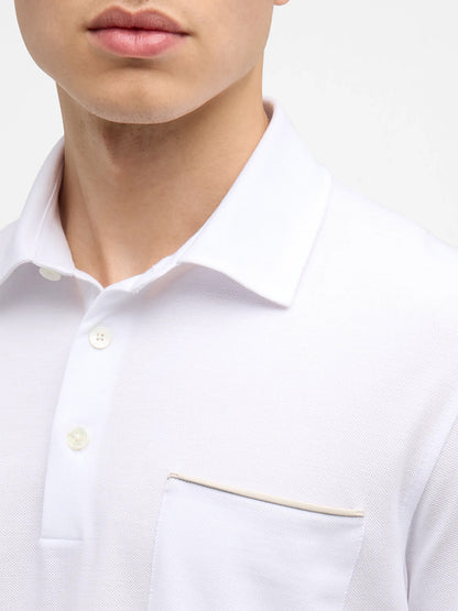 Close-up of a person wearing a Zegna Polo Pure Cotton Piqué with Leather Trim Pocket in White. The face is partially visible, showing the lower part with no distinctive features.