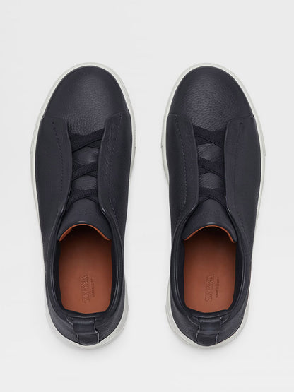 A pair of Zegna Navy Blue Deerskin Triple Stitch™ Sneakers with concealed laces under overlapping panels, viewed from above on a light background.
