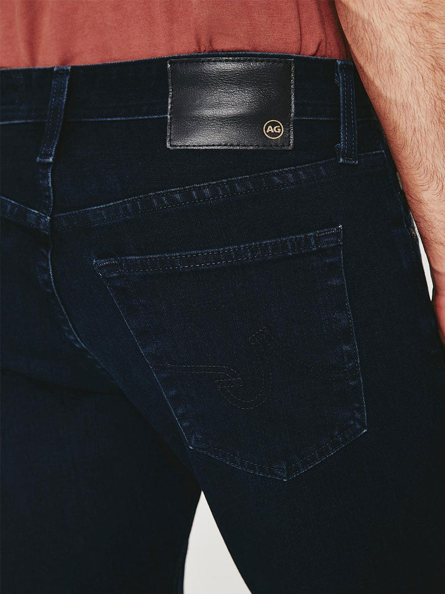 The back view of a man wearing AG Jeans Everett in Bundled with a pocket.