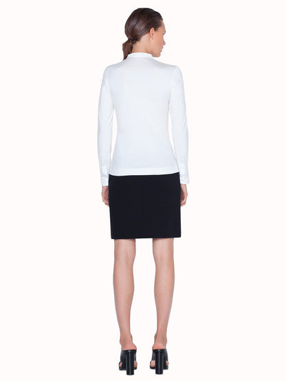 The back view of a woman wearing an Akris Punto Elements Long Sleeve Blouse and black skirt.