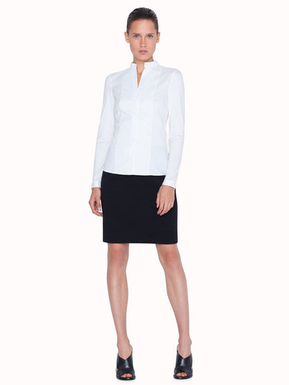 A woman in a Akris Punto Elements Long Sleeve Blouse and black skirt.