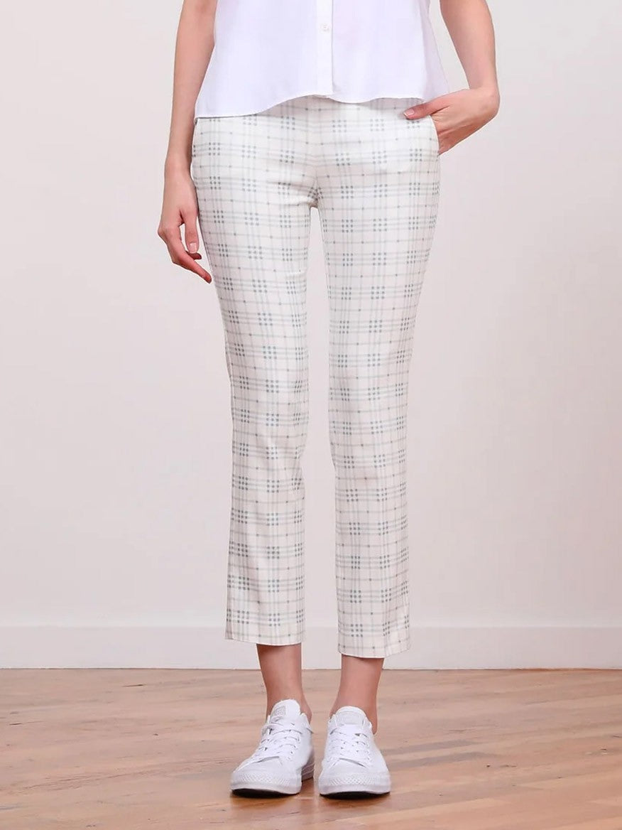 Description: A woman wearing Avenue Montaigne Lulu Plaid Blue Ankle Slim Pant with side pockets and white shoes.