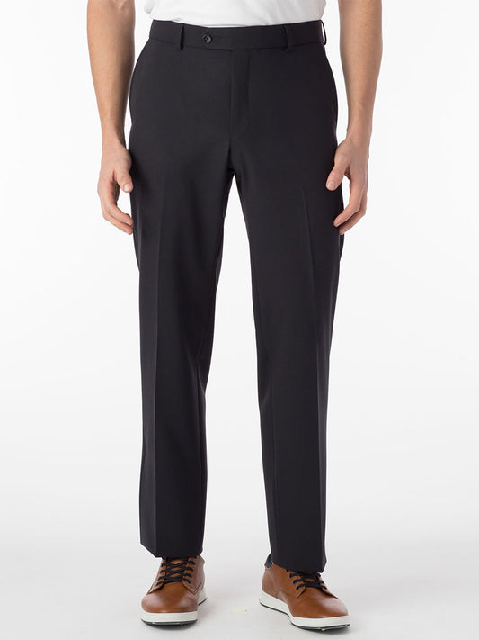 A person wearing navy modern flat front pants known as Ballin Connor Comfort 'EZE' and brown shoes stands against a plain white background.