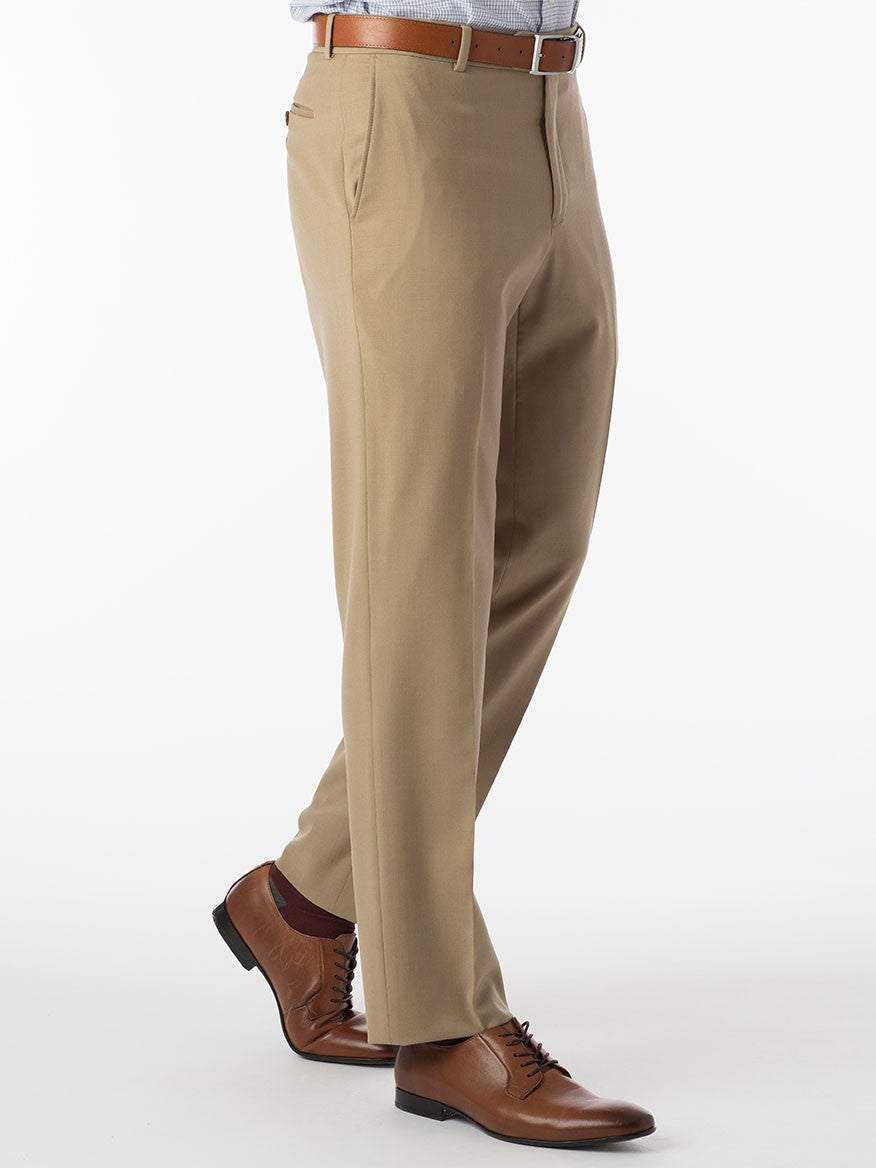 A man in a luxurious Ballin Theo Comfort 'EZE' Modern Flat Front Pant in Tan suit is standing on a white background.