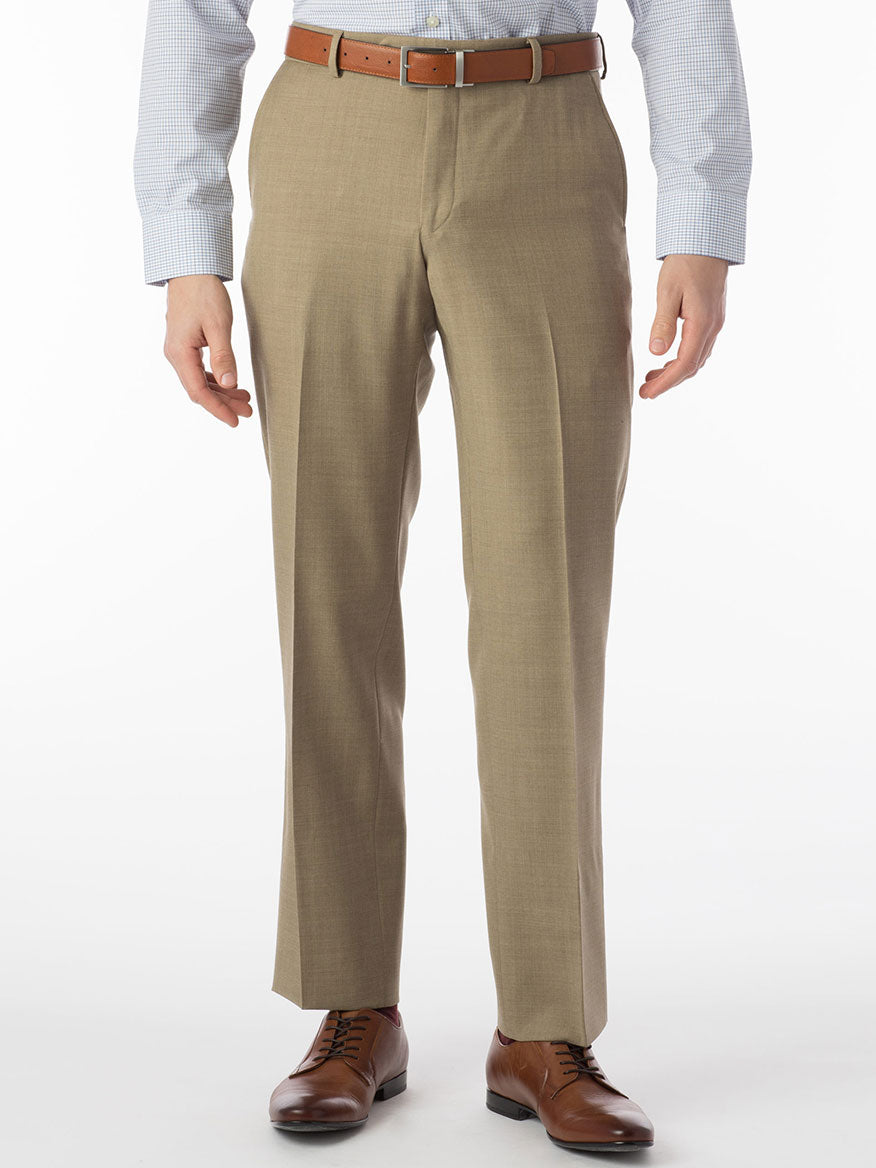 A man dressed in Ballin Soho Comfort 'EZE' Super 120s Modern Flat Front Pant in Tan exudes luxury and performance.