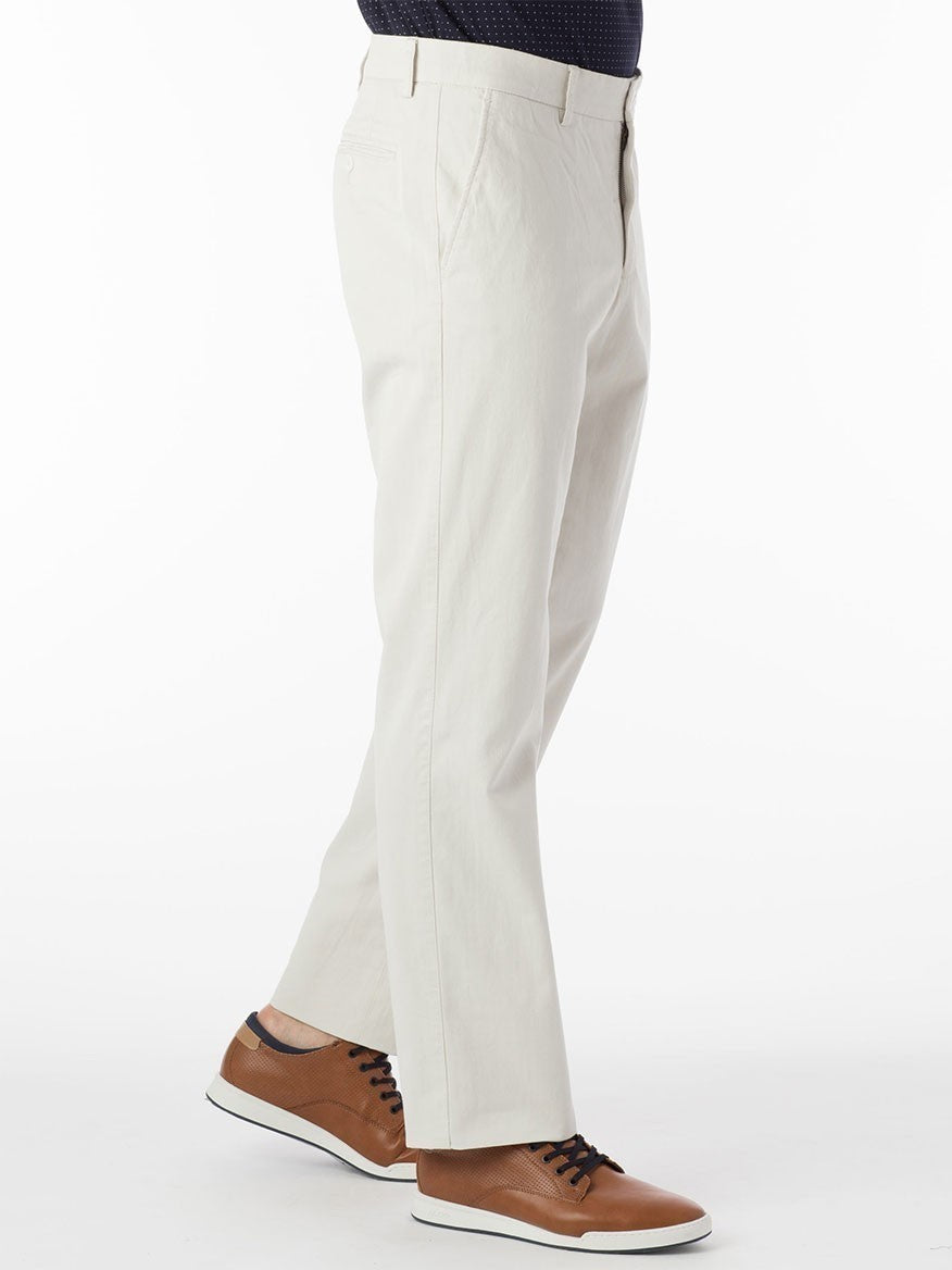 A person wearing the Ballin Atwater True Khaki Modern Flat Front Pants in Stone and brown sneakers stands against a white background.