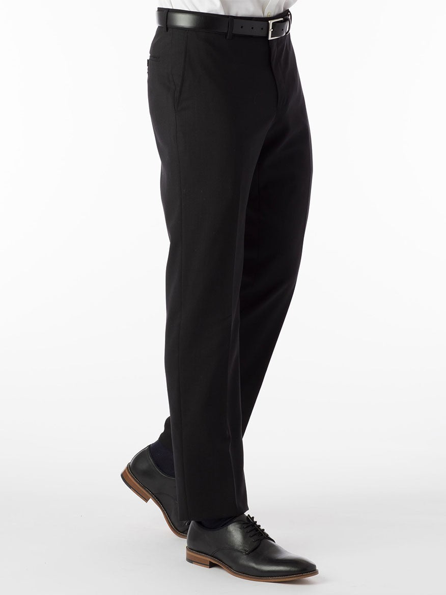 A man wearing Ballin Soho Comfort 'EZE' Super 120s Modern Flat Front Twill Pant in Black dress pants with a Comfort "EZE" waistband and a white shirt.