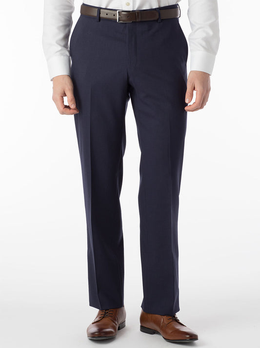 A man is standing in a Ballin Soho Comfort 'EZE' Super 120s Modern Flat Front Twill Pant in New Navy and tie with a Nanotex enhanced fabric.