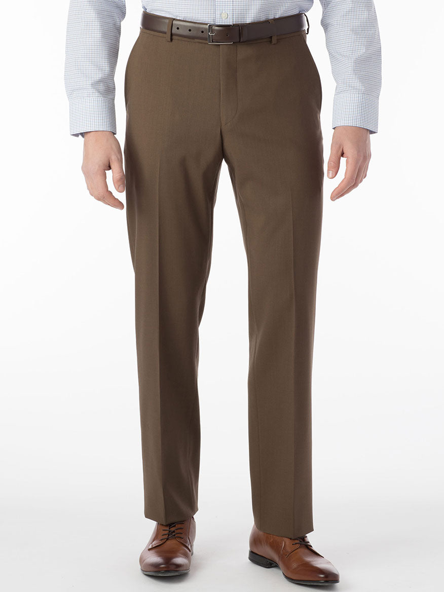 A man wearing brown dress pants with a comfortable "Ballin Soho Comfort 'EZE' Super 120s Modern Flat Front Twill Pant in Saddle" waistband and a white shirt.