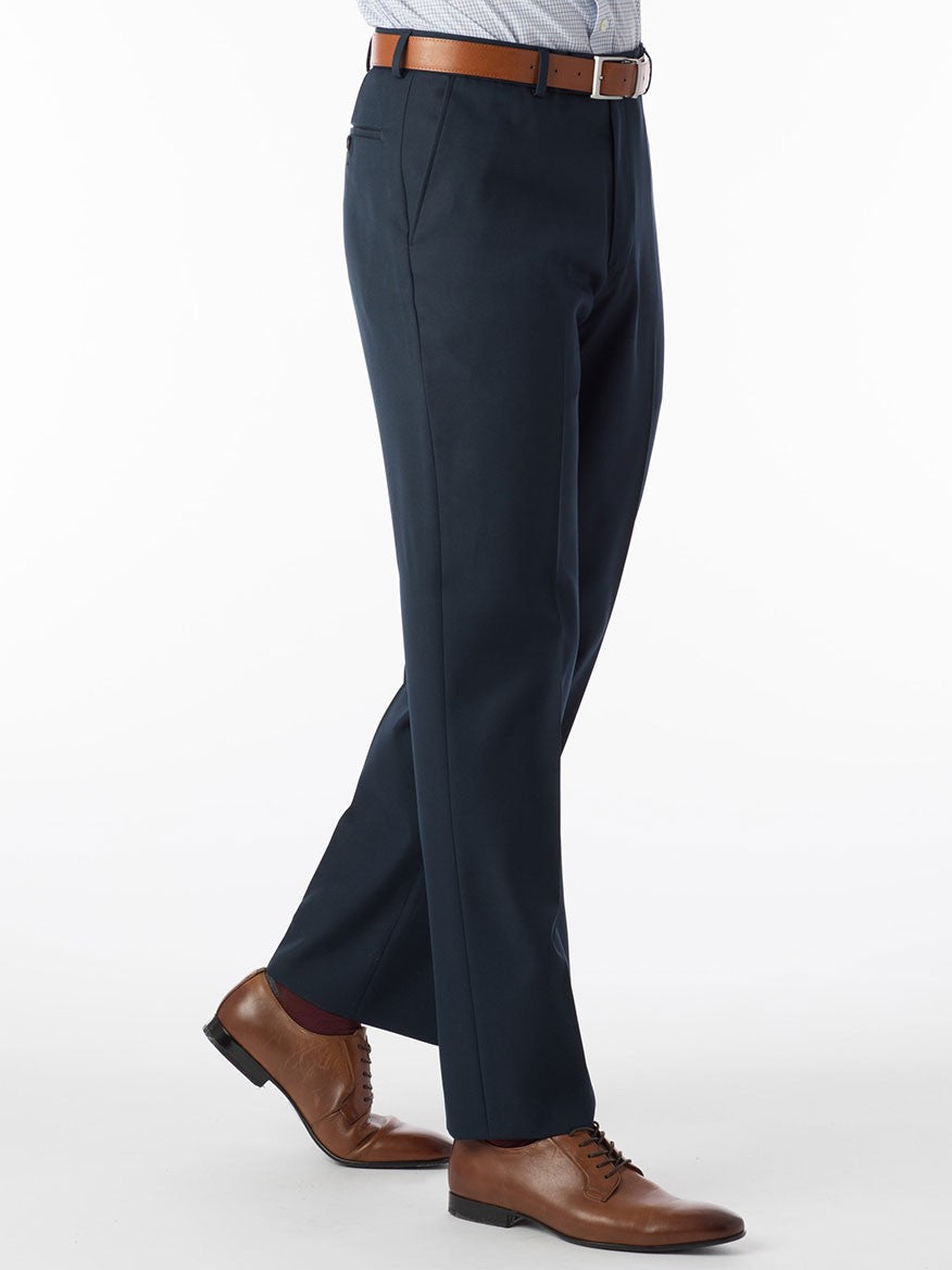 A man is standing in a Ballin Dunhill Micro Nano Traditional Flat Front Pant in Navy with Comfort "EZE" technology.