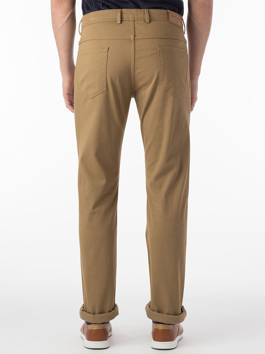 The man wearing Ballin Crescent Modern 5 Pocket Twill Pants in British Tan is seen from the back.