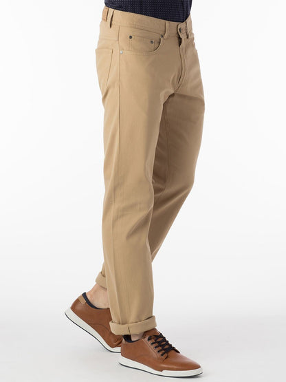 A man wearing Ballin Crescent Modern 5 Pocket Twill Pants in Khaki.