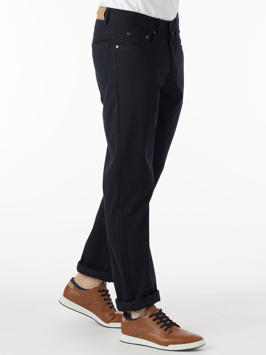 A man wearing a pair of Ballin Crescent Modern 5 Pocket Twill Pants in Navy and a t-shirt.