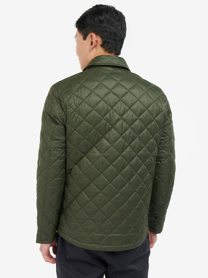A man in a quilted Barbour Newbie Quilted Jacket in Olive with stud fastenings.