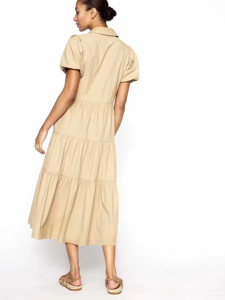 A woman in a Brochu Walker Havana Dress in Sahara with tiered ruffles viewed from the back, exuding feminine appeal.
