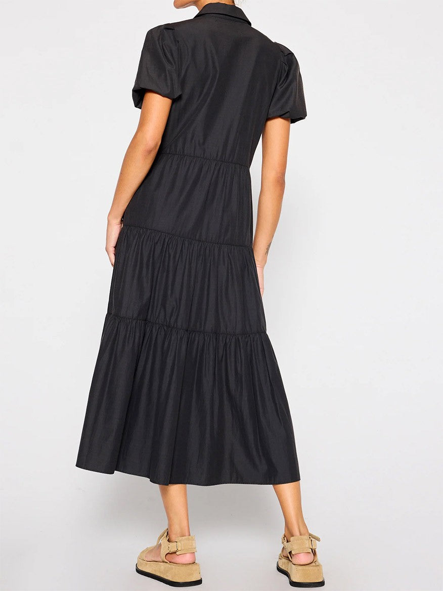 Woman modeling a versatile black tiered Brochu Walker Havana Dress in Washed Black from behind, exuding feminine appeal.