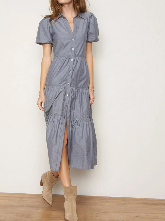 Woman wearing a versatile button-up Brochu Walker Havana Dress in Washed Slate with short sleeves and beige ankle boots, exuding feminine appeal.