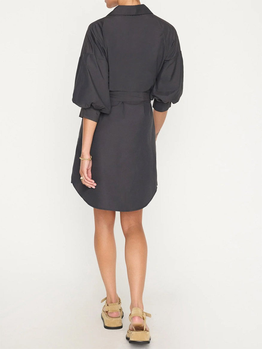 Woman standing with her back to the camera, exuding effortless sensuality in a Brochu Walker Kate Belted Dress in Washed Black with three-quarter sleeves and platform sandals.