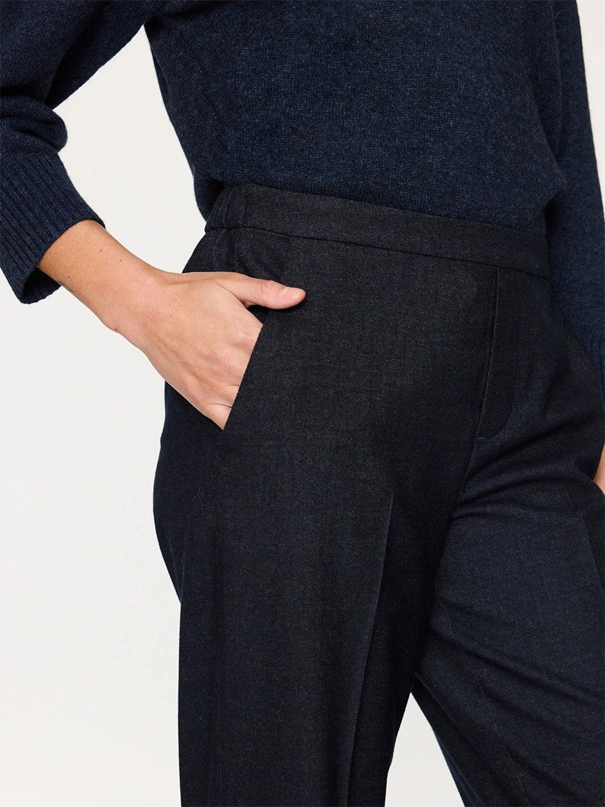 A person wearing a blue sweater and Brochu Walker Westport Brushed Pant in Navy Melange with a hand resting on the hip.
