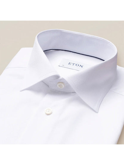 Close-up of a white Eton Slim Fit White Stretch Twill dress shirt with a spread collar and a visible brand label.