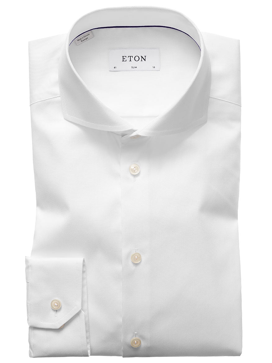 The Eton Slim Fit White Extreme Cut Away Dress Shirt features an extreme cut away collar and buttoned cuffs, neatly folded and displayed against a plain background.