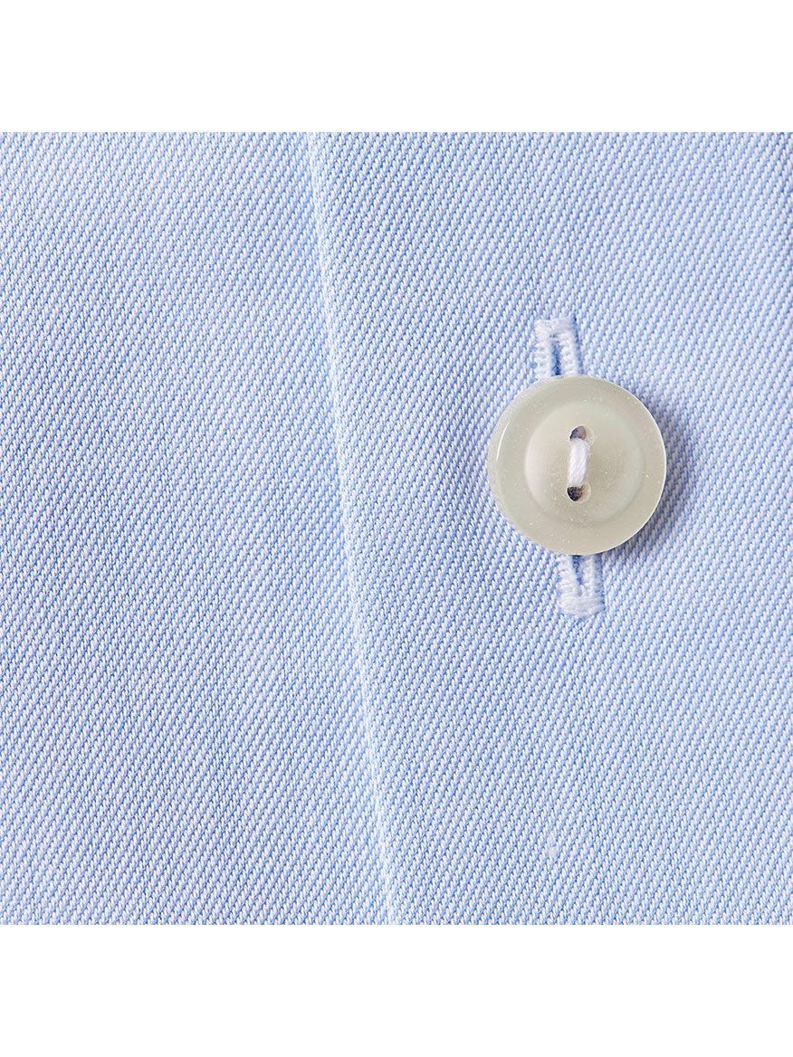 Close-up of the Eton Slim Fit Sky Blue Extreme Cut Away Dress Shirt, showing its diagonal weave texture, precise stitching, white button detail, and the edge of its extreme cut away collar.