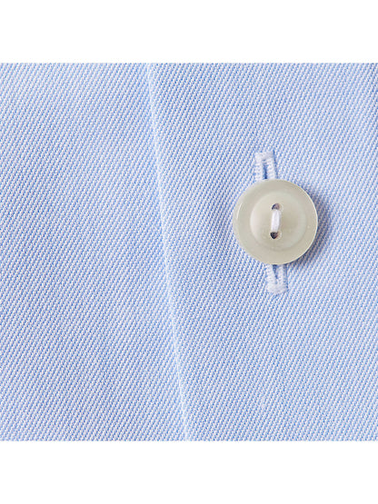Close-up of the Eton Slim Fit Sky Blue Extreme Cut Away Dress Shirt, showing its diagonal weave texture, precise stitching, white button detail, and the edge of its extreme cut away collar.