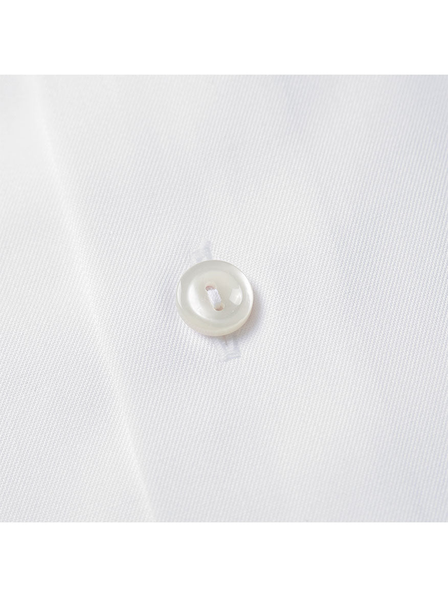 Close-up of a white button sewn onto the Eton Contemporary Fit White French Cuff Dress Shirt.
