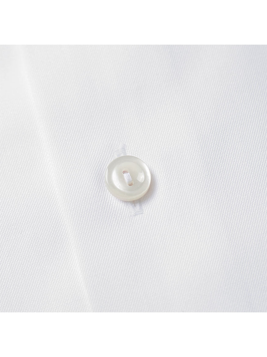 Close-up of a white button sewn onto fabric from the Eton Slim Fit White French Cuff Dress Shirt.