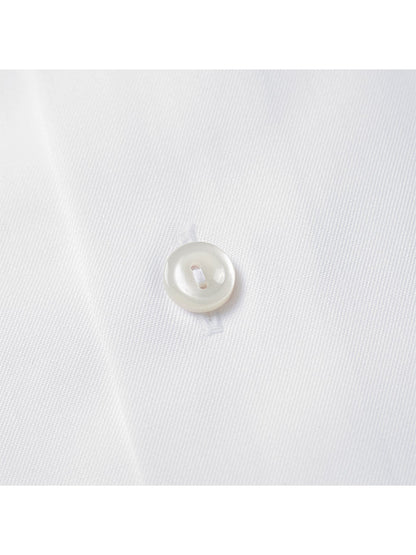 Close-up of a white button sewn onto fabric from the Eton Slim Fit White French Cuff Dress Shirt.
