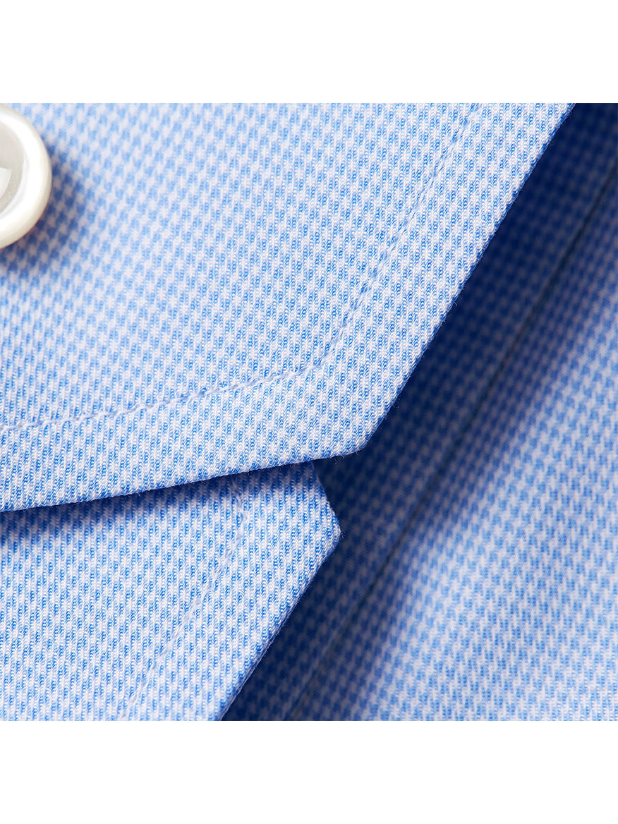 Close-up of a blue Eton Contemporary Fit Light Blue Houndstooth Dress Shirt fabric with a button, likely a shirt detail.