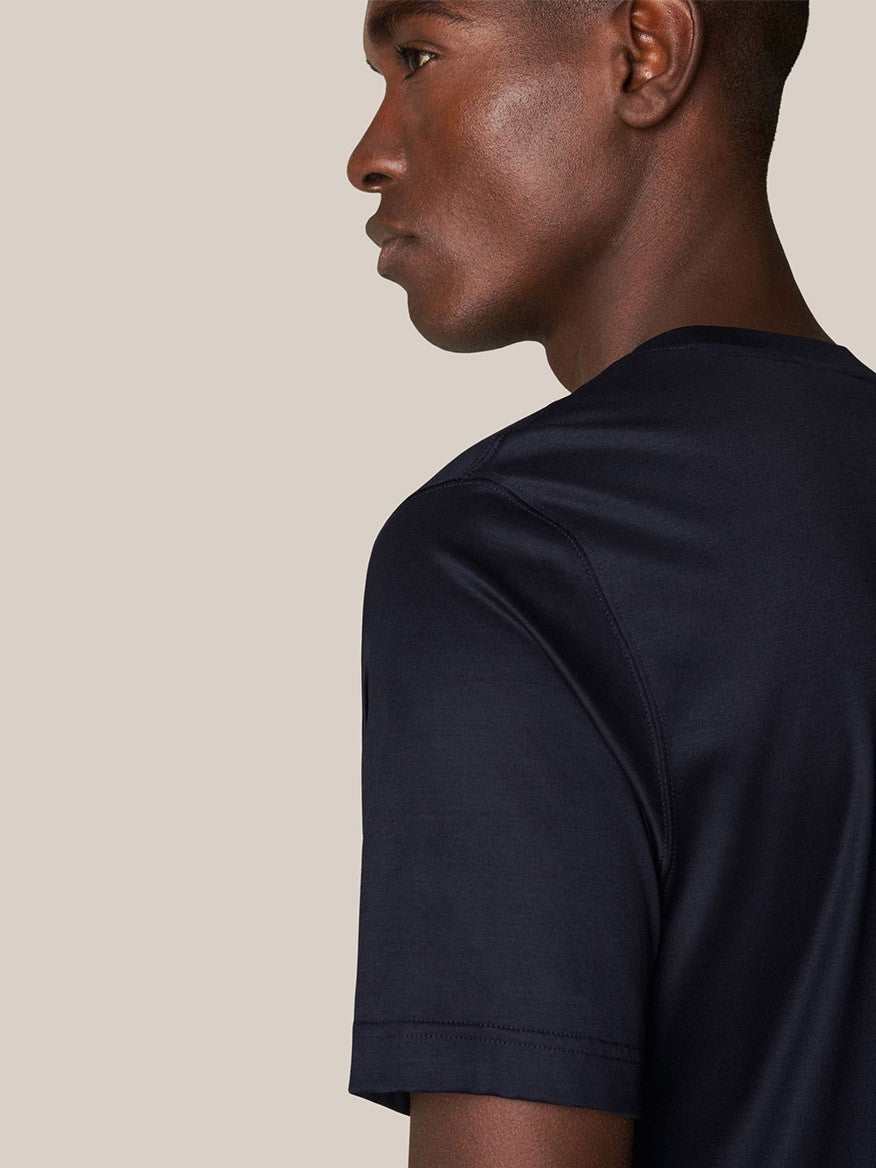Profile view of a person wearing a luxurious Eton Filo di Scozia T-Shirt in Navy against a neutral background.