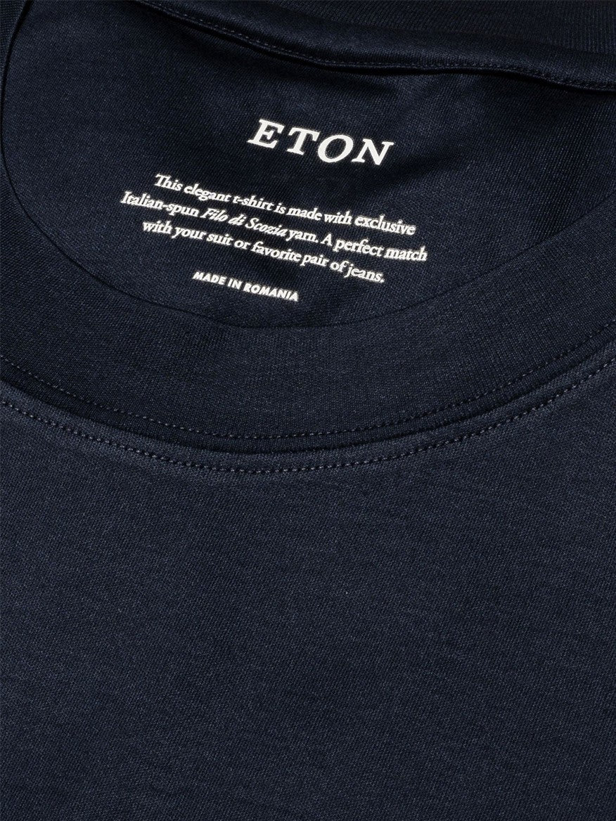 Close-up of a luxurious navy Eton Filo di Scozia T-Shirt label with care instructions and brand information.