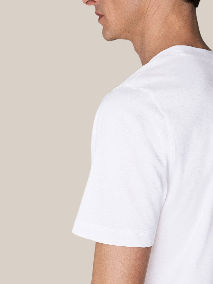 Side profile of a man wearing a luxurious Eton Filo di Scozia T-Shirt in White against a neutral background.