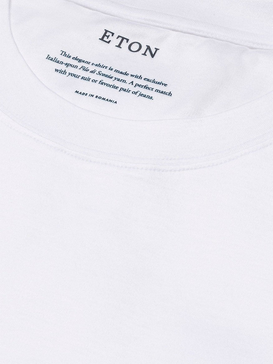 Close-up of a white Eton Filo di Scozia T-shirt label with care instructions for a luxurious t-shirt made from double mercerized yarn.