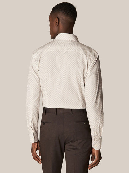 A man viewed from behind, wearing Eton's Brown Signature Poplin Shirt in Medallion Print and dark brown trousers, standing against a neutral background.