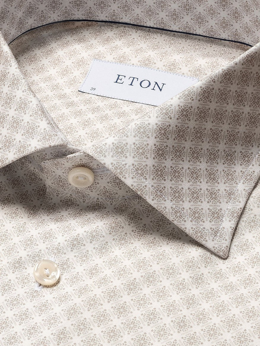 Close-up of an Eton Brown Signature Poplin Shirt in Medallion Print showing detailed texture on its fabric, collar, and a button.
