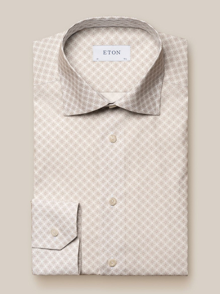 Folded Eton Brown Signature Poplin Shirt in Medallion Print, displayed on a beige background, featuring a pointed collar and the label "Eton's Signature Poplin" visible at the neck.