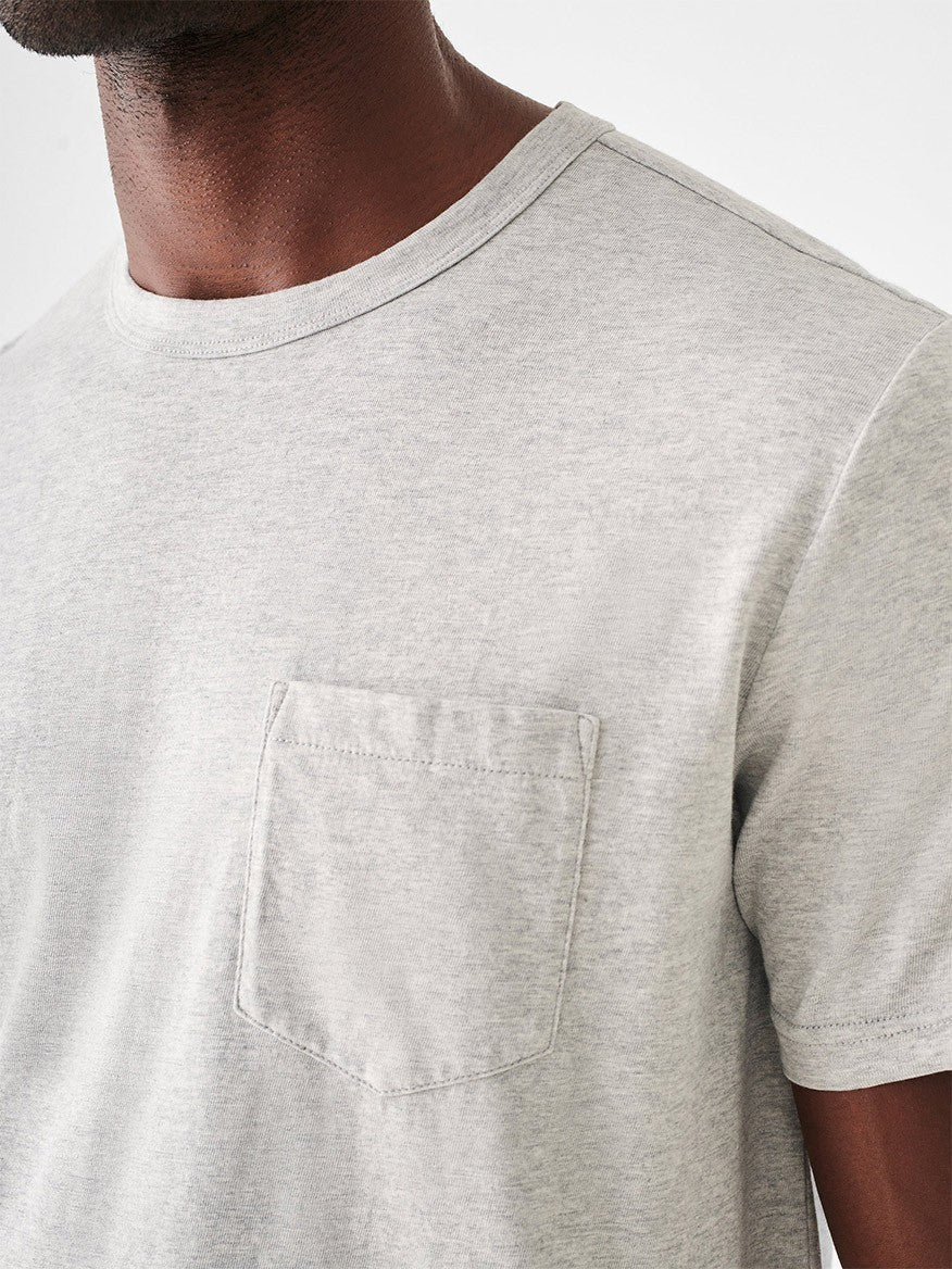 A man wearing a Faherty Brand Sunwashed Pocket Tee in Heather Grey shirt.