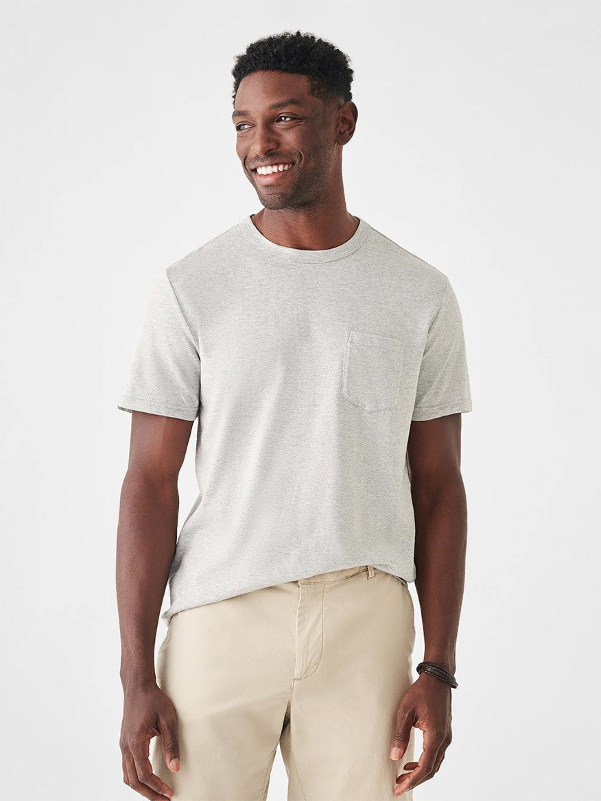 A man in a Faherty Brand Sunwashed Pocket Tee in Heather Grey.